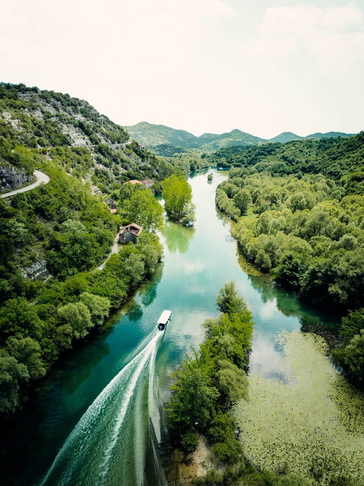 Aerial view of a boat crossing Lake Skadar, Montenegro